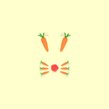 Flat lay Rabbit Head. The rabbit face is made of carrots, and one rose on bright yellow background. Easter minimal concept. 
