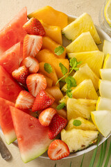 Summer fresh fruits assortment platter antipasti, watermelon, pineapple, melon and strawberries. 
