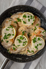 Homemade Creamy Lemon Chicken in a Pan, top view. Flat lay, overhead, from above.