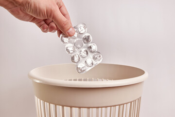The pill wrapper is thrown into the trash can. Plastic disposal and recycling.