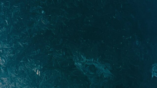 Beautiful Drone Aerial Top Down Of Frozen Lake with cracks and textures