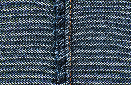 Denim texture, a surface of a back side jeans detail close up with a overlock split seam in the centre