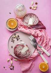 Halved radicchio on plate with forks and healthy salad ingredients, top view. Healthy food concept