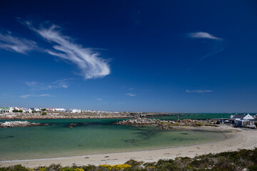 A view of Jacob's Bay, South Africa with green ocean and blue sky