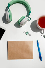 phone, head phones, note and stationery isoalted over background, business or educational tools, wok from home concept