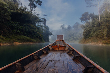 Long tail boat trip on a Cheow Lan lake in a national park Khao Sok, Surat Thani province in...