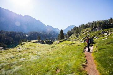 Fototapeta premium Young hiker girl summit to Ratera Peak in Aiguestortes and Sant Maurici National Park, Spain