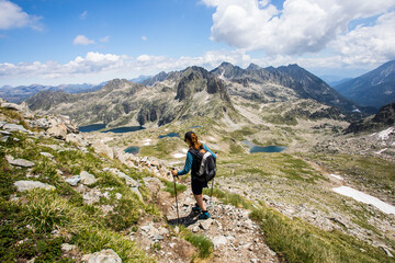 Young hiker girl summit to Ratera Peak in Aiguestortes and Sant Maurici National Park, Spain