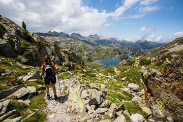 Fototapeta premium Young hiker girl summit to Ratera Peak in Aiguestortes and Sant Maurici National Park, Spain