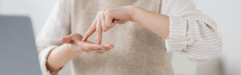 cropped view of woman showing stand word while teaching sign language, banner.