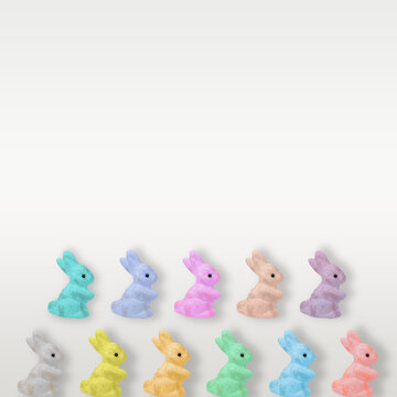 Creative Easter pattern made of styrofoam rabbits painted in pastel colors and tinsel. Flat lay.