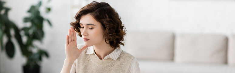 brunette curly woman showing symbol meaning mother on sign language during lesson at home, banner. © LIGHTFIELD STUDIOS