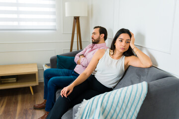 Sad couple feeling bad after fighting at home