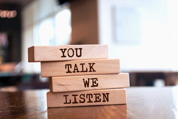 Wooden blocks with words 'You Talk We Listen'.