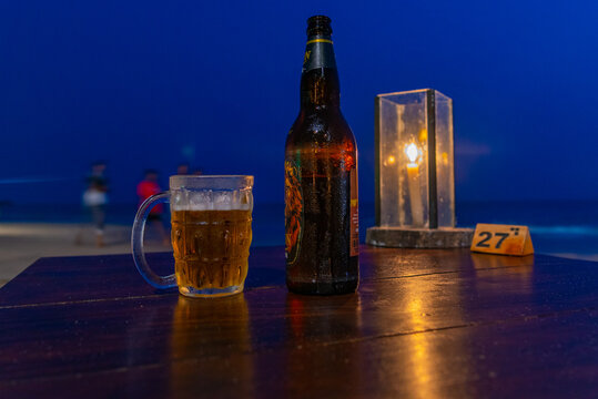 Beer on a table on a beach at Mirissa during night, Sri Lanka
