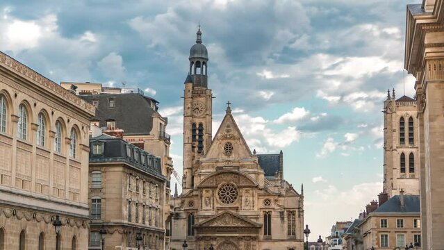 Church of Saint-Etienne-du-Mont timelapse in Paris near Pantheon. It contains shrine of St. Genevieve - patron saint of Paris. Clock on the tower. Cloudy sky at summer day