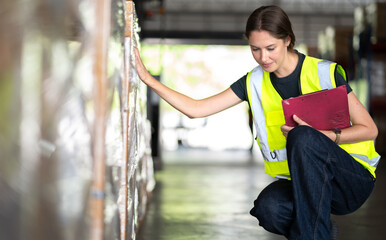Fototapeta premium Warehouse manager woman working at logistics distribution factory. Female store supervisor checking and counting inventory in storehouse as order delivery. Commercial engineer doing her job, portrait