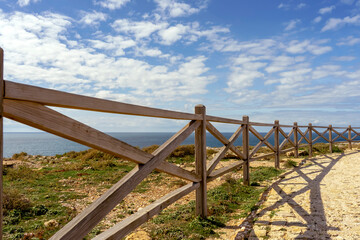Obraz premium Wooden bridge to sightseeing place on Algarve coast outside Lagos, Portugal. Portuguese beaches and shores of the city of Lagos. 
