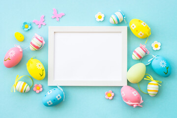 Easter background with Eggs, rabbit and spring flowers at blue background.