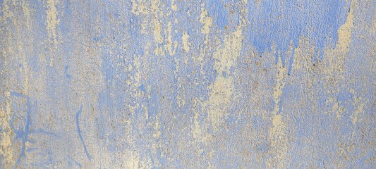 The texture of a panel painted several times with scuffs and streaks. Blue, gray background.