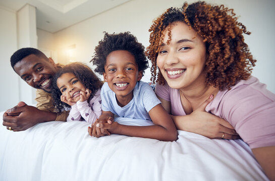 Portrait, selfie and happy family relax in bed, smile and cheerful in the home during morning together. Face, photo and children resting indoors with parents and pose for profile picture and memory