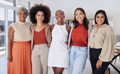 Portrait of a diverse group of smiling ethnic business women standing together in the office. Ambitious happy confident professional team of colleagues embracing while feeling supported and empowered - Powered by Adobe