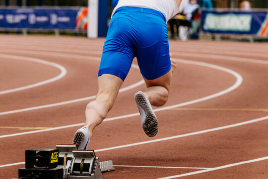 athlete sprinter start running from starting blocks Alge-Timing, world championship athletics competition, sports editorial photo