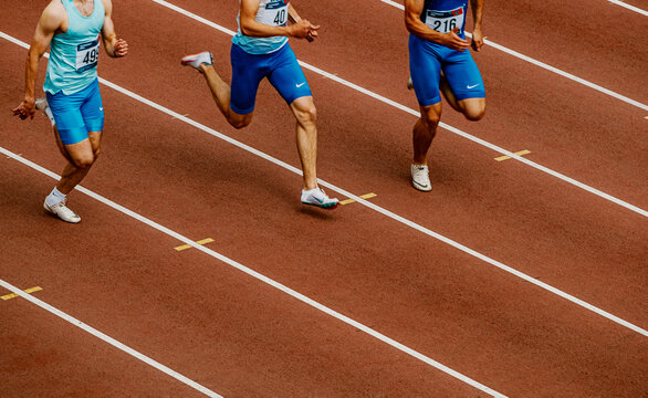 male athletes runners in sprinting spikes Nike run race at stadium, world championship athletics competition, sports editorial photo