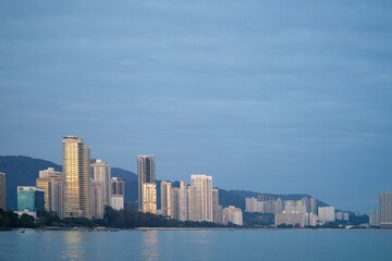 Modern high rise building city scape along the seaside during sunrise.
