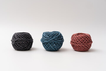 Various roll of earth colour string on isolated white background
