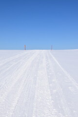 A snowmobile trail in a field , Québec, Canada