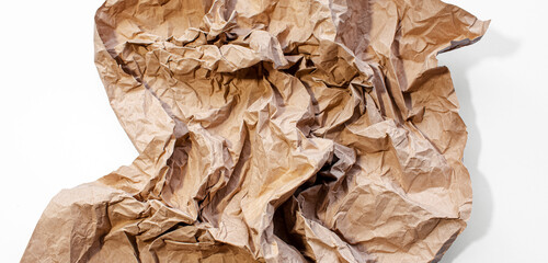 Crumpled paper of beige color isolated on white background.