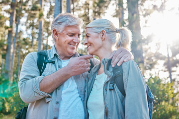 Love, nature and senior couple on a hike together in a forest while on outdoor weekend trip. Happy,...