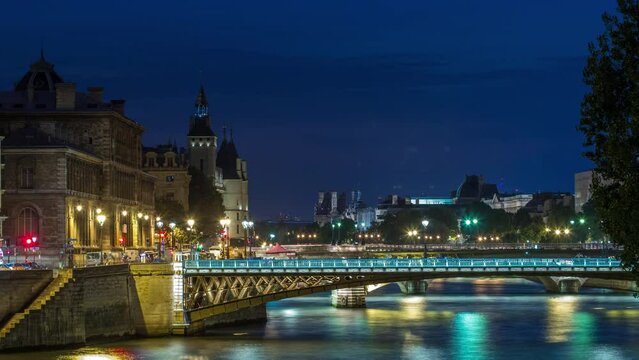 Le Pont D'Arcole bridge after sunset with boats day to night transition timelapse, Paris, France, Europe. Colorful sky at summer day with reflection on river Seine