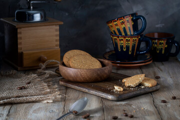 Round cookies in a brown plate on a wooden table