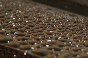 macro photo of water drops on metal