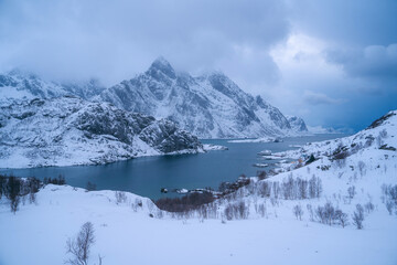 Fototapeta na wymiar Stunning winter landscape of the Lofoten Islands in Norway. The mountains in the background rise up majestically, with their peaks covered in snow. Majestic natural wonders of the world. Travel