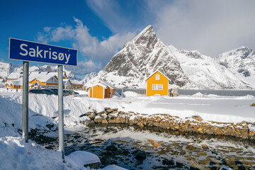 Sakrisoy village in winter. Classic view of Lofoten Islands architecture - traditional wooden fishing houses rorbu at picturesque mountain peaks