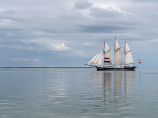 Obraz premium Traditional three-mast clipper sailing on IJsselmeer lake, Netherlands