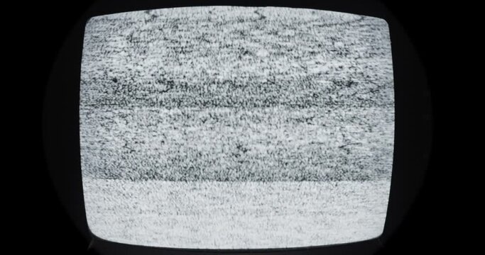 Vintage Obsolete Technology Background Texture of old black and white television which no longer can receive a transmission signal showing static and snow.