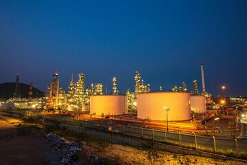 Night scene of oil refinery plant and storage white tank oil of Petrochemistry industry