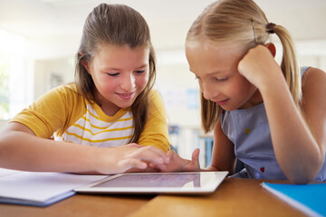 Tablet, kindergarten and girls in classroom for elearning, education and online knowledge. Friends, technology and happiness of kids or students with touchscreen in preschool for studying together.