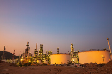 Fototapeta na wymiar Twilight scene of oil refinery plant and storage white tank oil of Petrochemistry industry