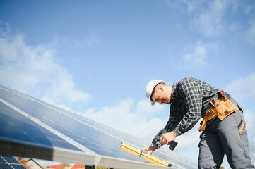 Men technicians installing photovoltaic solar moduls. Concept of alternative and renewable energy.