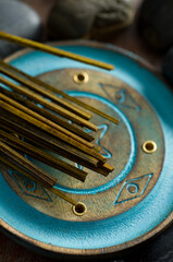 Macro of Blue Incense Holder and Incense Sticks