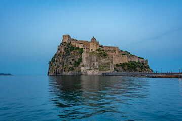 Sunset view of Castello Aragonese off the coast of Italian island Ischia