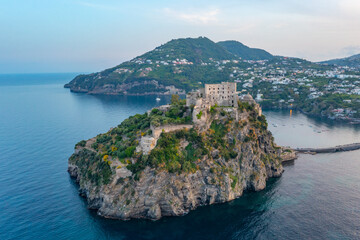 Sunset view of Castello Aragonese off the coast of Italian island Ischia
