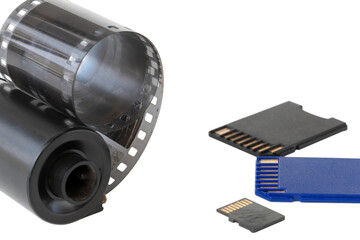 Micro SD card against vintage roll film in reel, on isolated background