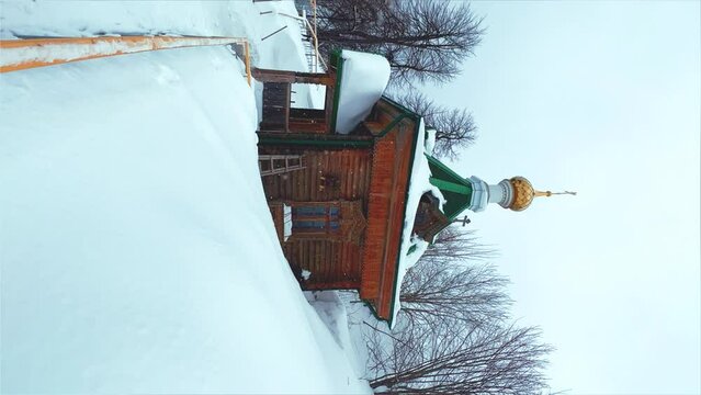 View of the chapel near the Belogorsky St. Nicholas Orthodox Missionary Monastery. Winter forest. The temple on the hill in winter. Russia, Perm Krai, Belaya Gora. 4K