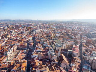 Aerial perspective of Valladolid city center at sunrise. View of Plaza Mayor and Cathedral of Valladolid. Sun in the right corner of the camera. Beautiful panoramic view of the city. 